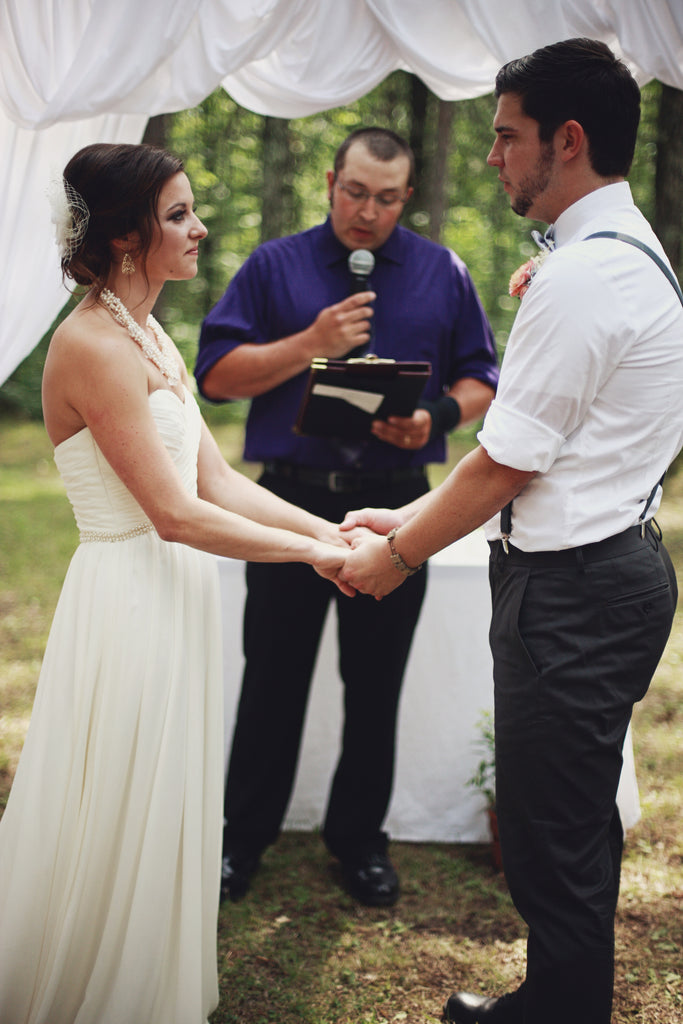 The bride and groom during the gorgeous, outdoor wedding ceremony. | A Whimsical Gold and Pink Wedding Day