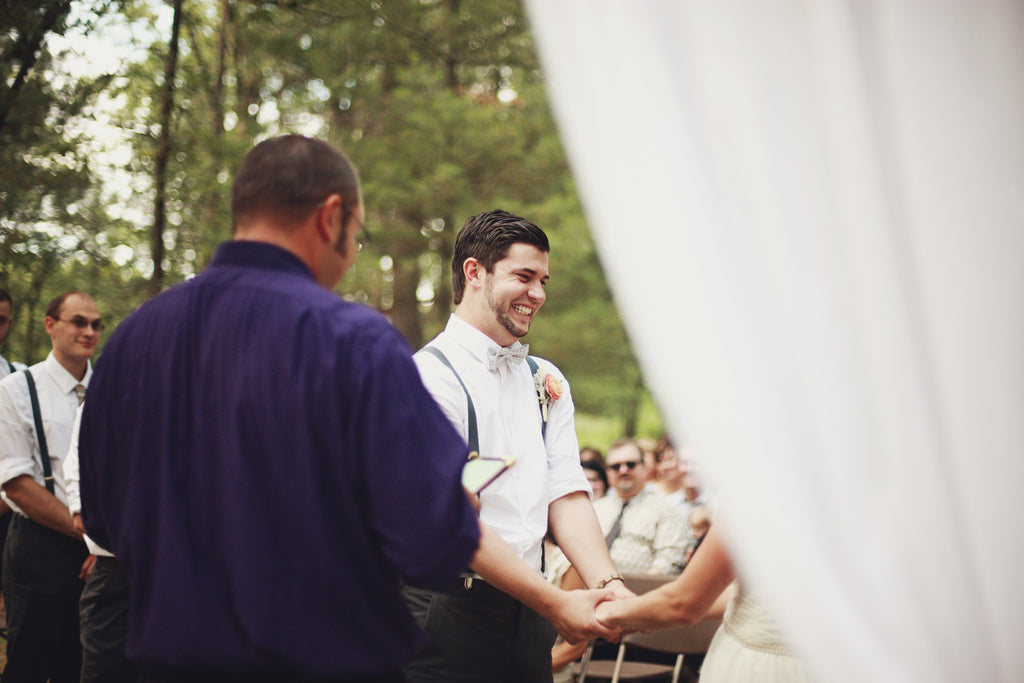 A fun shot of the happy groom from the outdoor wedding ceremony. | A Whimsical Gold and Pink Wedding Day