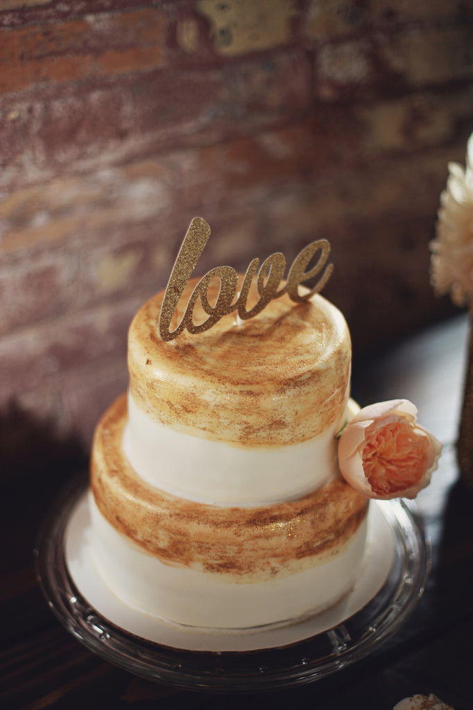 A hand painted, gold wedding cake. | A Whimsical Gold and Pink Wedding Day