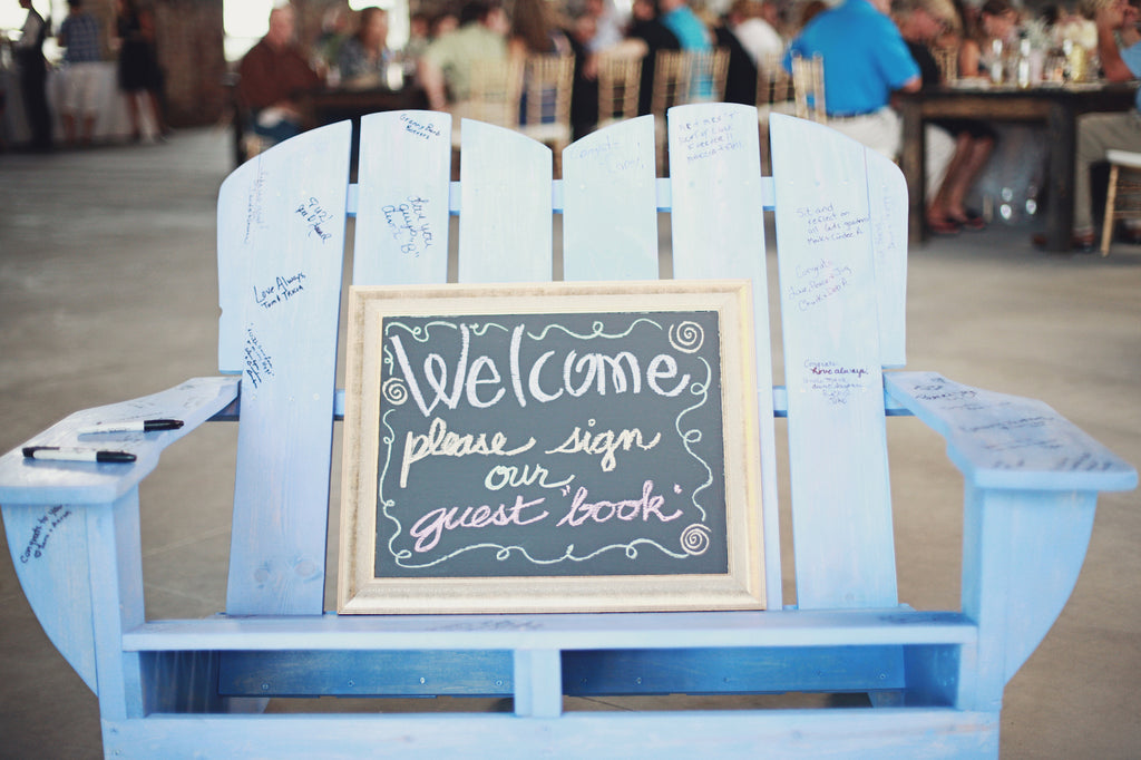 A wooden chair is a unique guestbook idea. | A Whimsical Gold and Pink Wedding Day