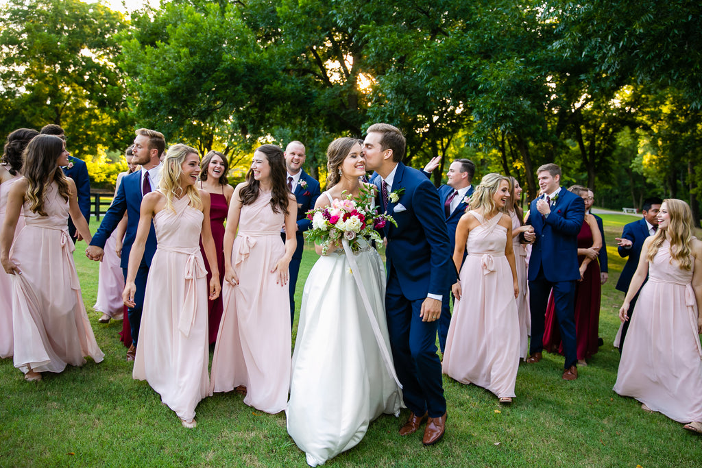 Chase's groomsmen in Navy suits complement Madison's bridesmaids in Blush and Bordeaux perfectly! 