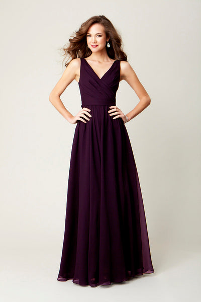 A long, chiffon bridesmaid dress in eggplant is perfect for a winter-themed wedding.