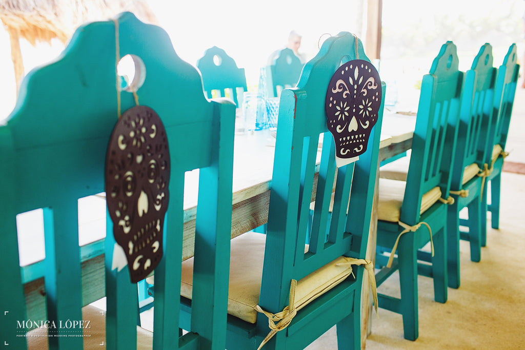 Colorful chairs with sugar skulls as decorations. | A One-Of-A-Kind Destination Wedding