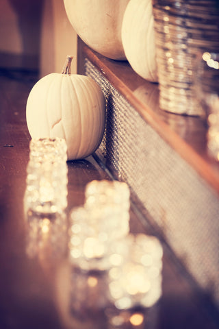 White pumpkins and candles for fall wedding decor. | A Fall Wedding Filled With Elegance and Style