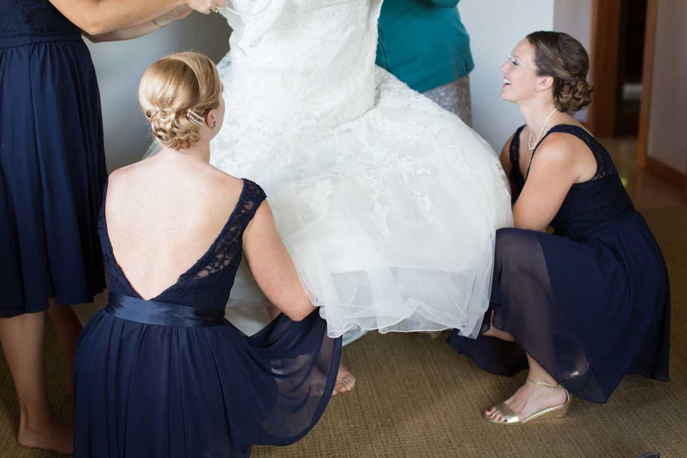 A stunning low-back bridesmaid dress in navy.