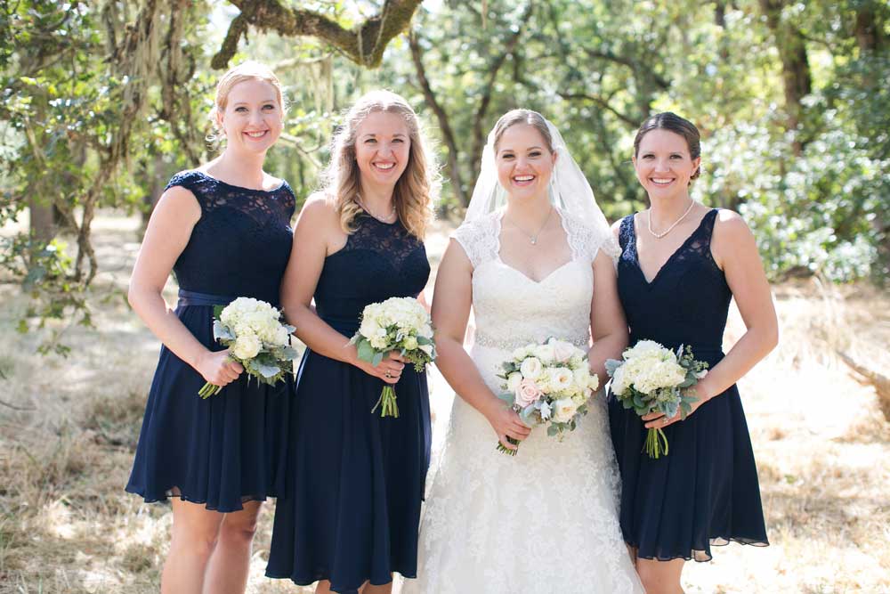 Mix and match navy, lace-top bridesmaid dresses.