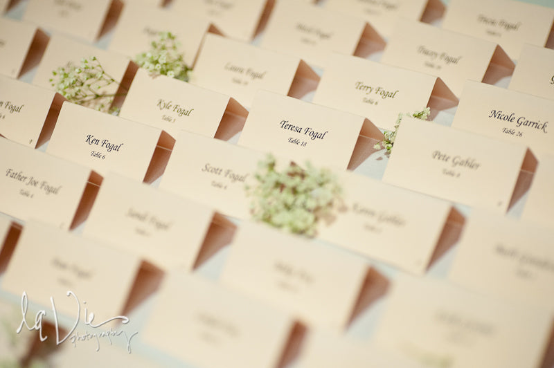 Simple escort cards adorned in stems of baby's breath. | A Simply Chic Wedding Day | Your Something Blue