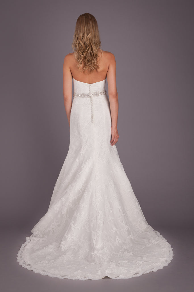 The back on this fitted lace bridal gown is simple, yet chic! | Featured Style: A Lace Fit and Flare Wedding Dress