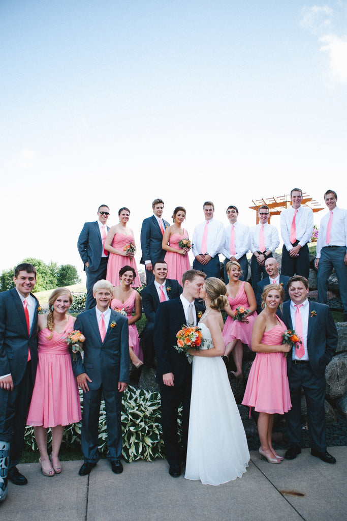 A stunning bridal party with coral bridesmaid dresses and men's ties! | An Outdoor Wedding That’s Simply Charming | Kennedy Blue