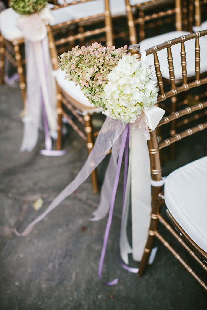 Flowers and ribbon were used for wedding ceremony decor | A Chic Purple and Gold Pittsburgh Wedding