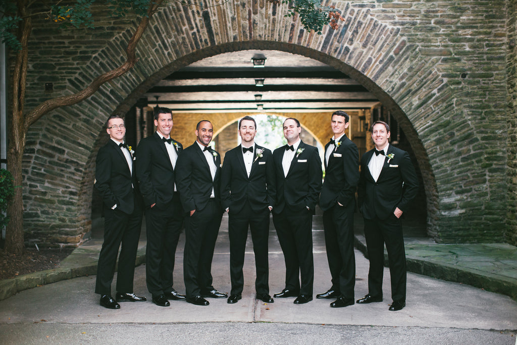 The groom and groomsmen wore black suits and bowties | A Chic Purple and Gold Pittsburgh Wedding