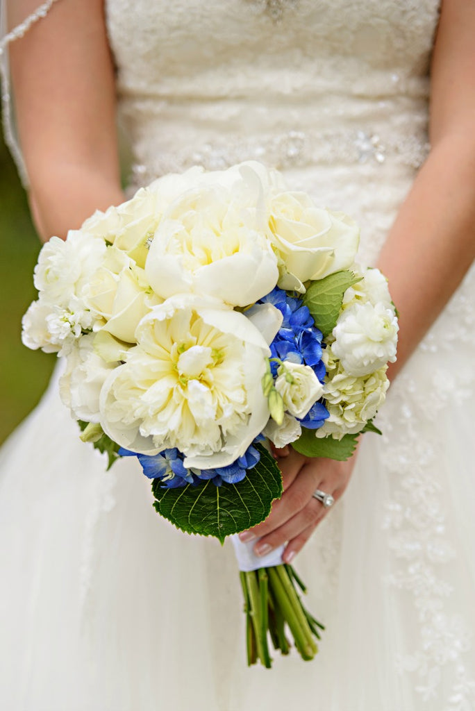 Blue accent flowers in wedding bouquet