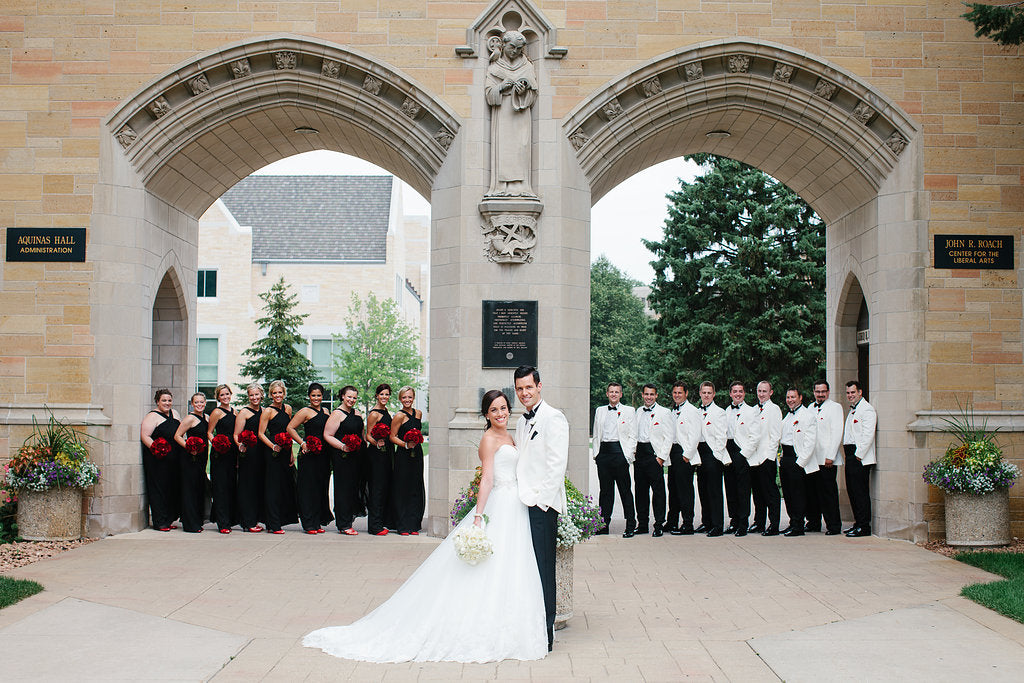 An elegant black and white wedding; this group took wedding photos under the University of St. Thomas arches. | A Timeless and Traditional Mansion Wedding