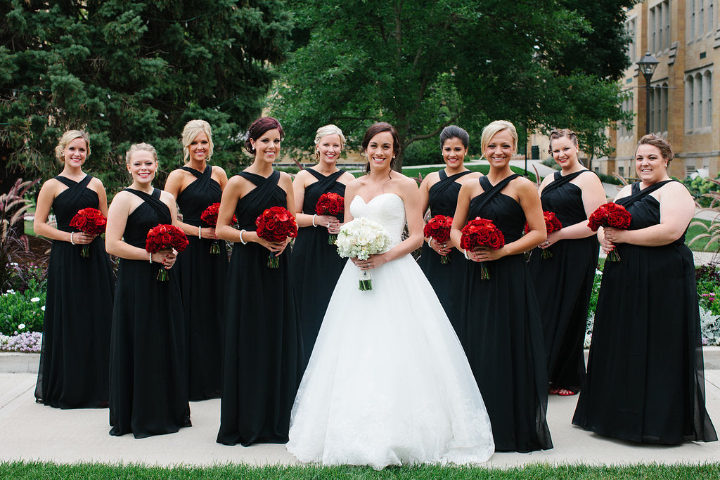 These bridesmaids were gorgeous in their Kennedy Blue black bridesmaid dresses and red rose bouquets! | A Timeless and Traditional Mansion Wedding