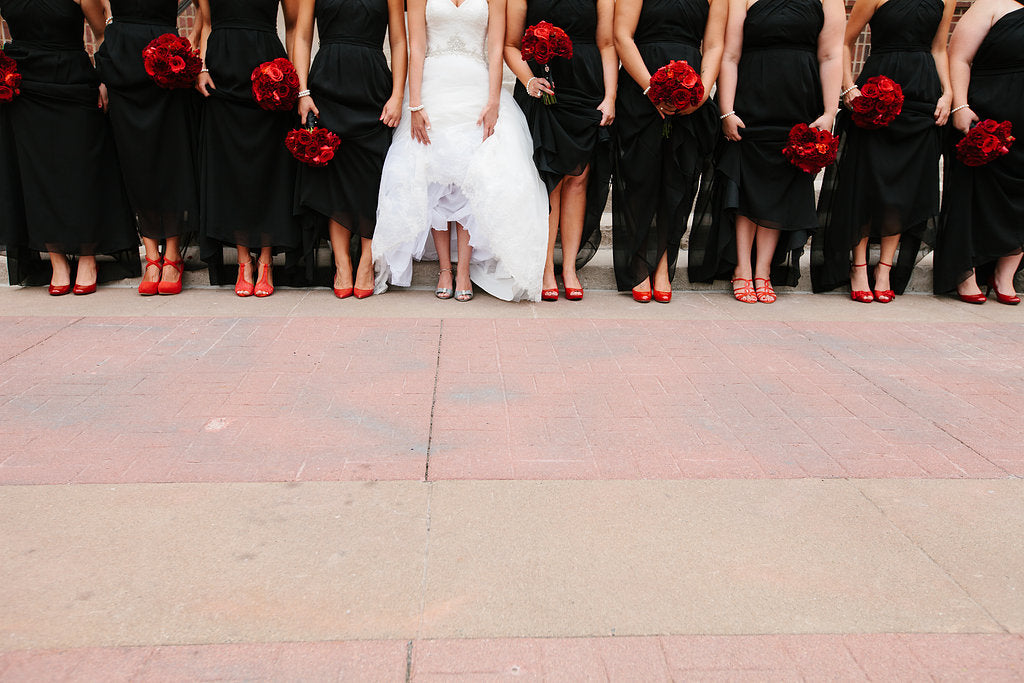 These ladies created a mix-and-match look by each wearing their own red shoe. | A Timeless and Traditional Mansion Wedding