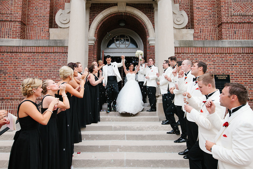 The couple's ceremony exit from the Chapel of St. Thomas Aquinas in St. Paul | A Timeless and Traditional Mansion Wedding