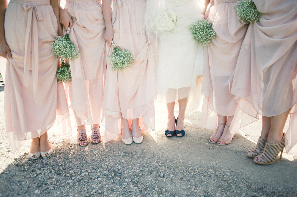 Blush pink bridesmaid dresses with trendy, mismatched shoes.