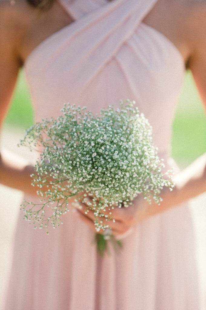 A baby's breath bouquet with blush pink bridesmaid dresses is such a soft and sweet combination.