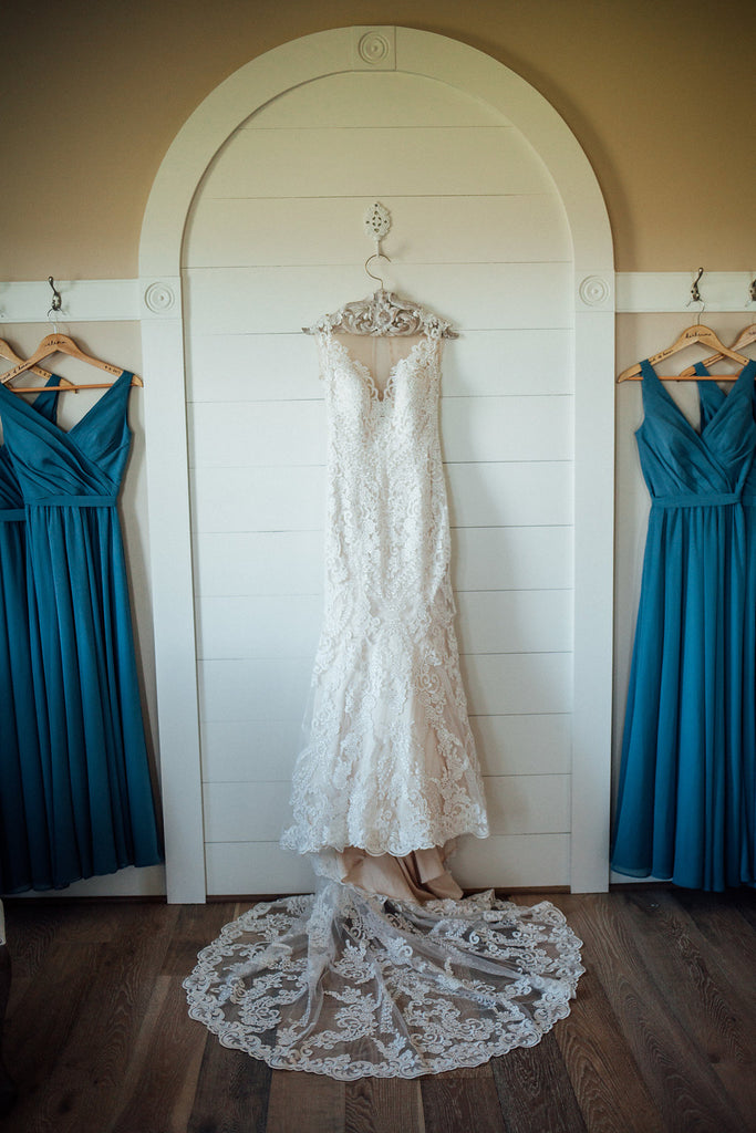 Wedding-Gown-Hanging-Emily-Caleb-Featured-BrideStory-Real-Wedding