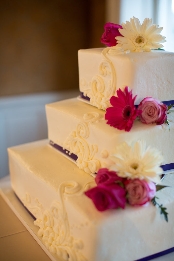 A gorgeous and classic tiered wedding cake. | A Romantic Jewel-Tone Wedding