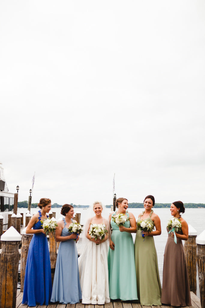 Gorgeous mismatched bridesmaid dresses in different colors. | A Simple Wedding Dress for a Lakeside Ceremony