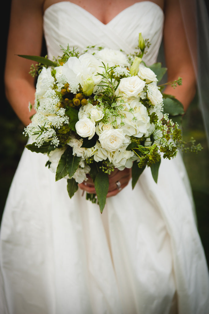 A white and green bouquet for the bride. | A Simple Wedding Dress for a Lakeside Ceremony