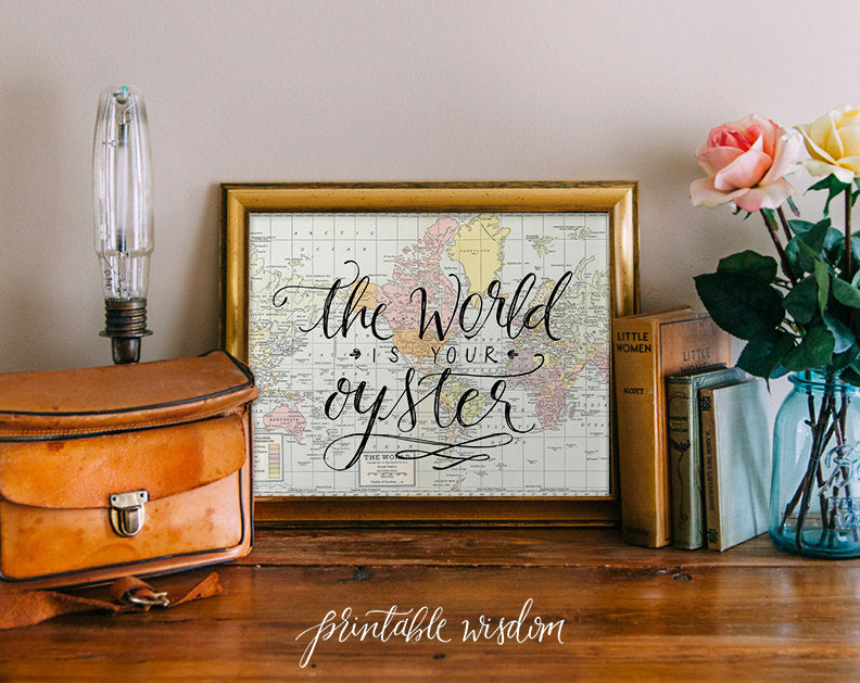 World map print with the quote "the world is your oyster" | Ways to Use Maps and Globes in Your Wedding Decor