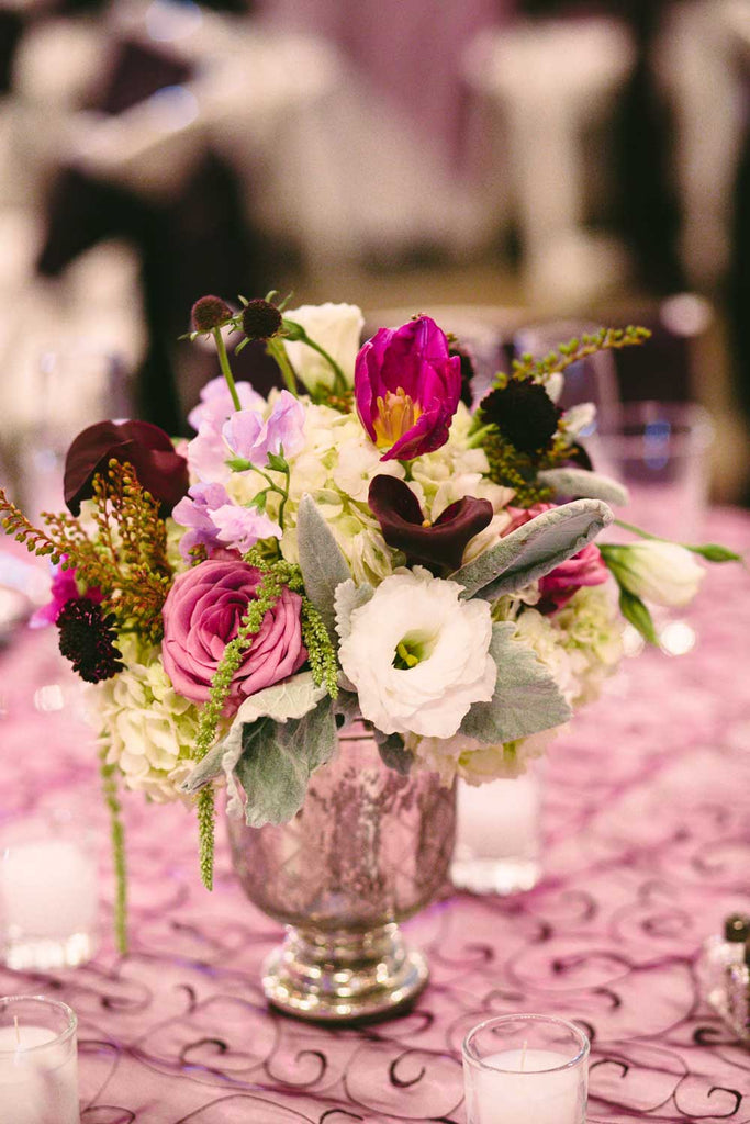 Make double use out of the bridesmaid bouquets by incorporating them into the table centerpieces.