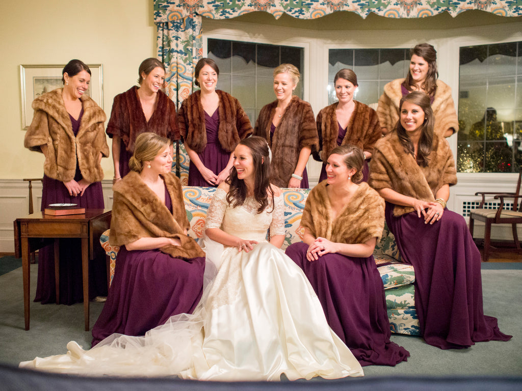 These 'maids covered their long chiffon bridesmaid dresses with warm fur coats. | A Romantic Winter-Themed Wedding