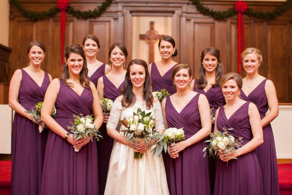 These girls wore full-length chiffon, purple bridesmaid dresses for Sarah's winter wedding. | A Romantic Winter-Themed Wedding