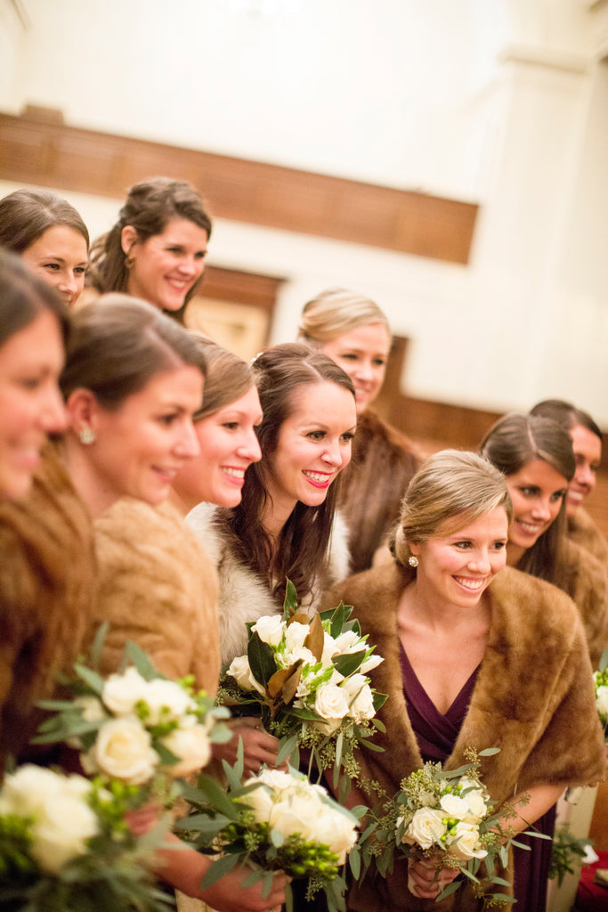 Fur coats are a stunning addition to chiffon bridesmaid dresses for a winter wedding. | A Romantic Winter-Themed Wedding