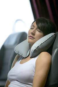 Woman sleeping on airplane with Super Snoozer Pillow Design Go