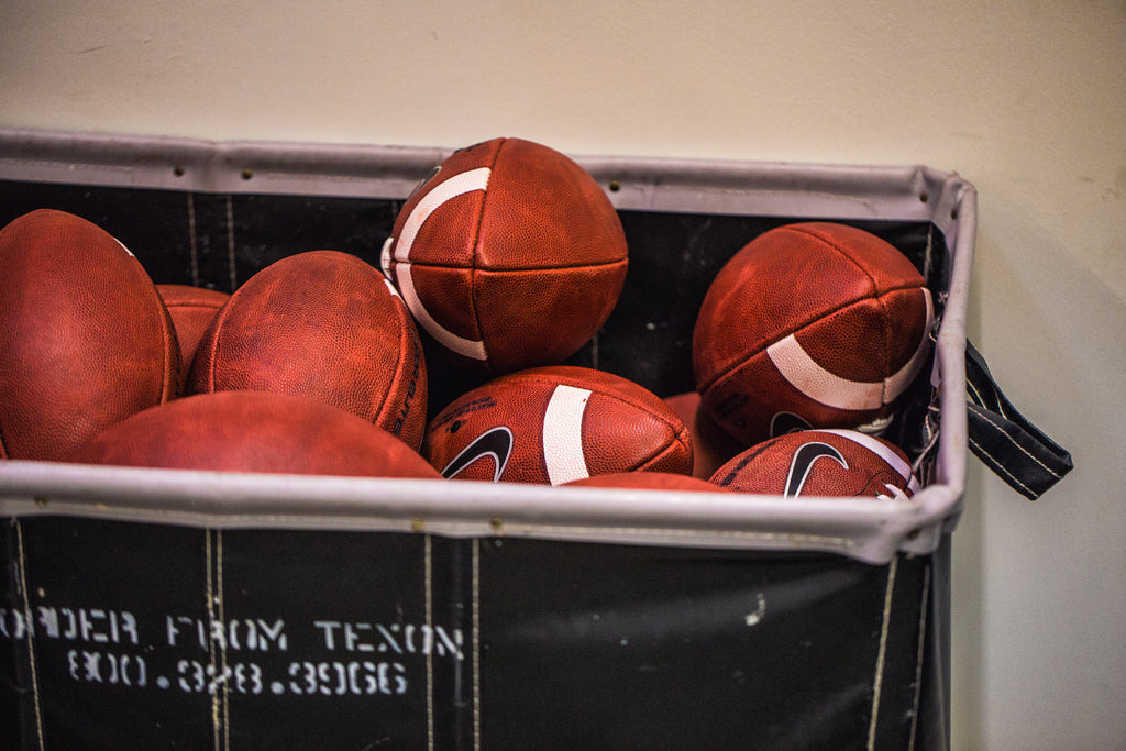 A basket of Big Game USA footballs