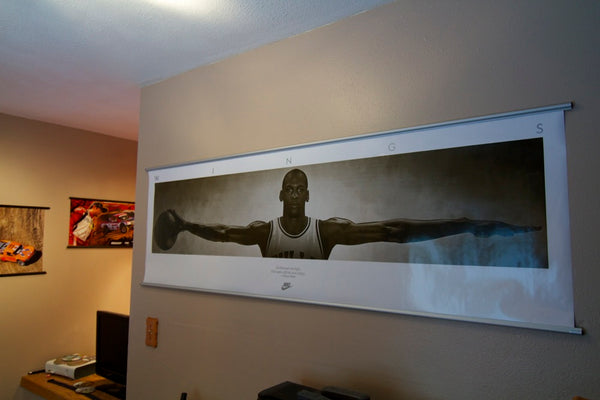 Michael Jordan Wings poster hanging on bedroom wall with 72 inch silver aluminum poster hanger