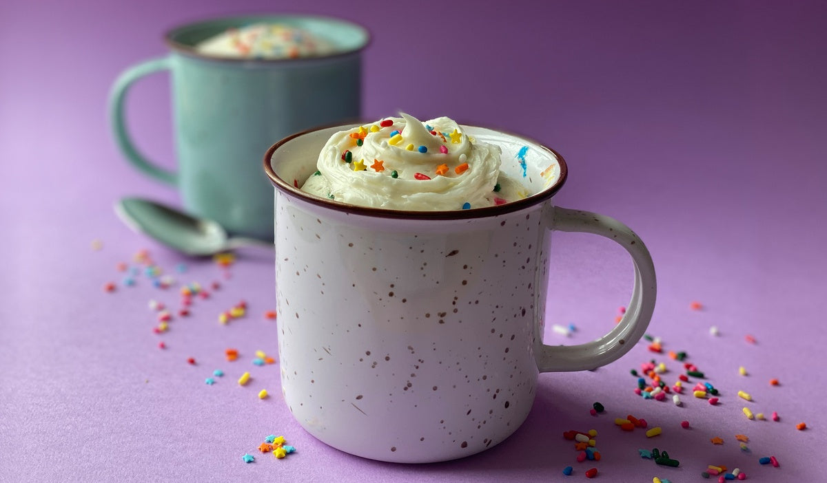 cake in a mug with vanilla icing