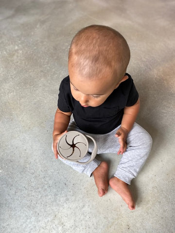 Child Development Specialist Cathy Wojcik's son using his dust-resistant Eizzy Baby Snack Cup