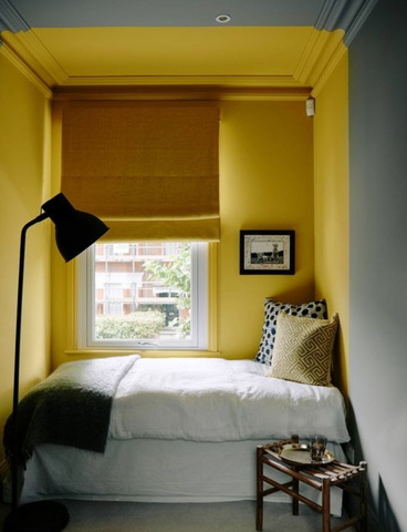 yellow and green bedroom with white bed