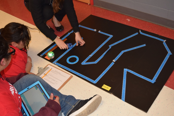 Students programming BOLT robot doing beginner maze tape activity.