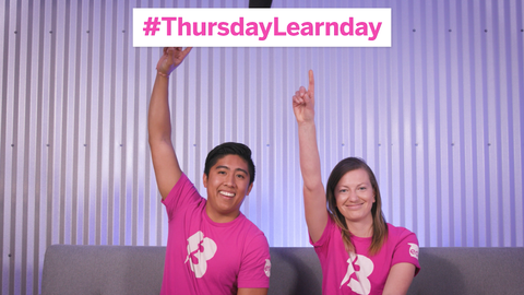 Two Sphero employees in pink BOLT shirts sitting at desk for #ThursdayLearnDay
