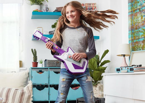 Girl playing with littleBits music inventor activity.