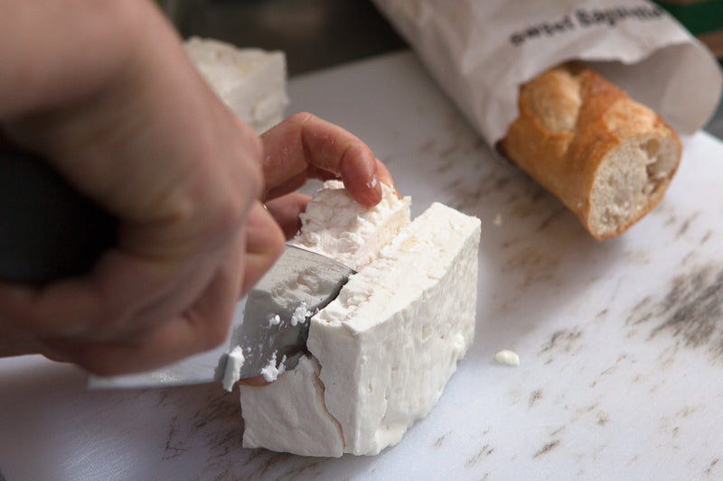 Chef cutting cheese - Feta Lesbos by Mia Nakano
