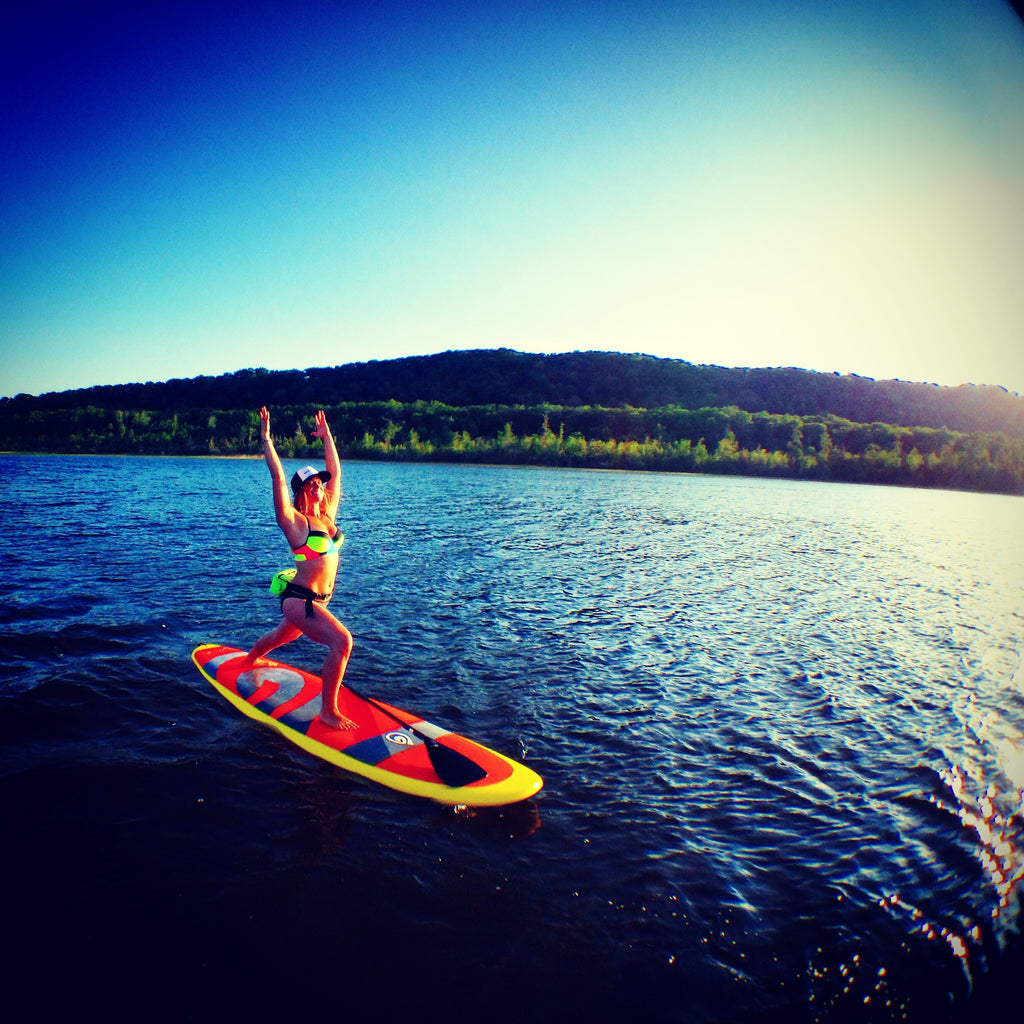 sup yoga on a paddle board