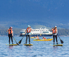 paddle boards with ferrie in background