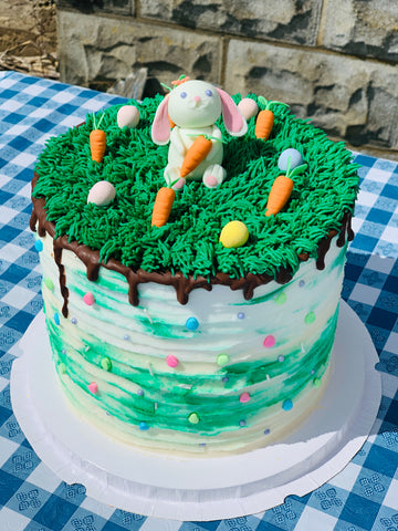 green bunny and carrot cake on table