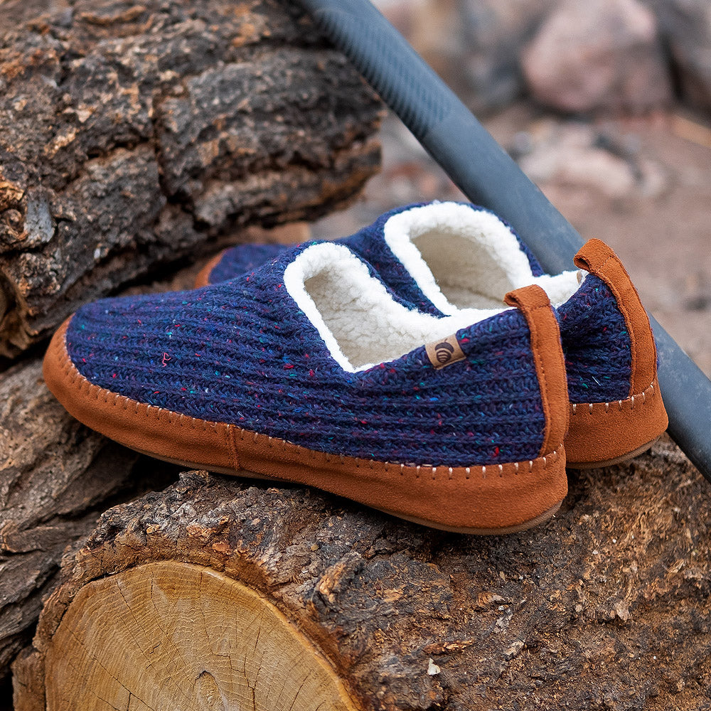 Camden mocs in Navy Blue sitting on a pile of wood