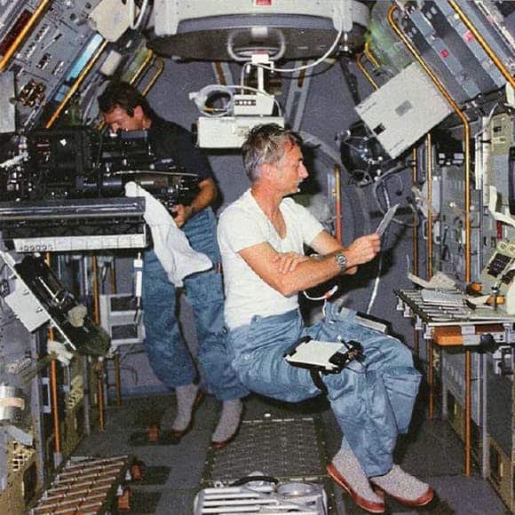 Two Male Astronauts Wearing Slipper Socks on the Space Shuttle
