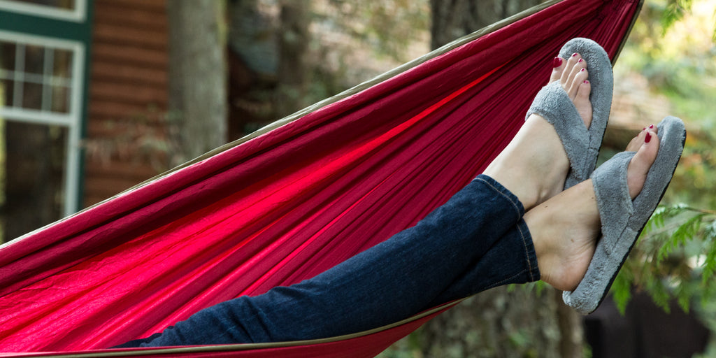 Woman lounging in a hammock wearing spa thong slippers
