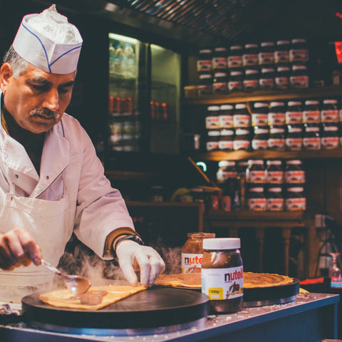French creperie owner making a crepe