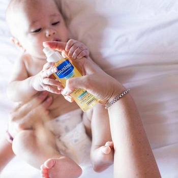 Baby and mom with Mustela's baby oil