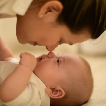 happy mom snuggling baby knowing aloe vera benefits